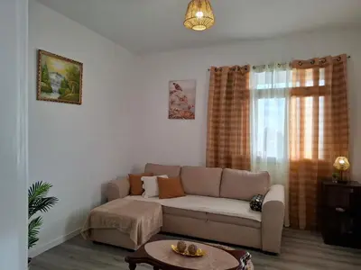a bedroom with a large bed with two night stands at Varanda Encantada House in Ponta do Sol