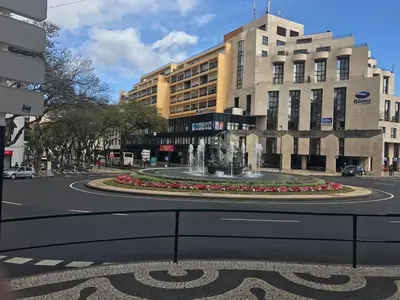 a fountain in the middle of a street with buildings at Top Floor Apartment 805 in Funchal