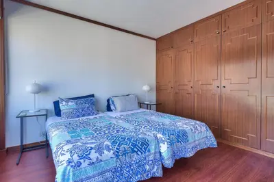 a bedroom with a bed and a large wooden cabinet at Top Floor Apartment 805 in Funchal