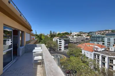 a balcony with chairs and a view of a city at Top Floor Apartment 805 in Funchal