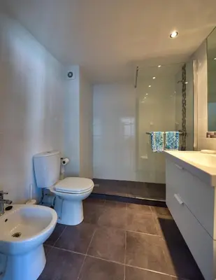 a bathroom with a toilet and a sink and a shower at Top Floor Apartment 805 in Funchal
