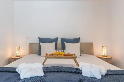 a bedroom with a bed with a tray of food on it at Julianas House 2 by Atlantic Holiday in Campanário