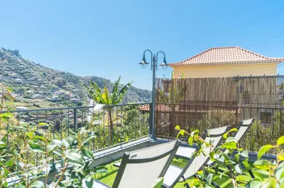 a group of chairs sitting on top of a balcony at Julianas House 2 by Atlantic Holiday in Campanário