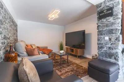 a living room with a couch and a tv at Julianas House 2 by Atlantic Holiday in Campanário