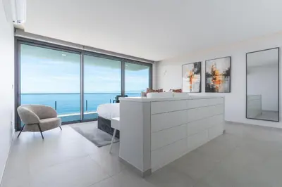 a bedroom with a bed and a view of the ocean at Villa Zenha by Atlantic Holiday in Ribeira Brava