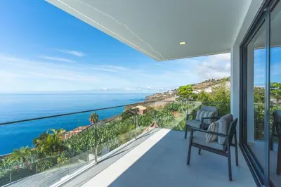 a view of the ocean from the balcony of a house at Villa Zenha by Atlantic Holiday in Ribeira Brava