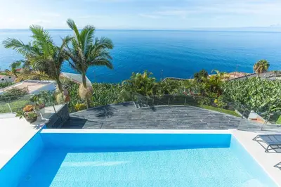 a swimming pool with a view of the ocean at Villa Zenha by Atlantic Holiday in Ribeira Brava