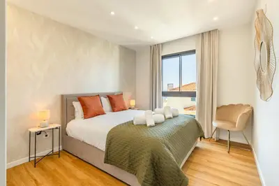 a bedroom with a bed and a window at Garajau Sea Side by Atlantic Holiday in Caniço