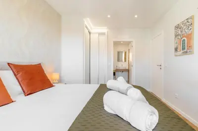 a bedroom with a large white bed with white pillows at Garajau Sea Side by Atlantic Holiday in Caniço