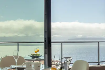 a dining room with a view of the ocean at Garajau Sea Side by Atlantic Holiday in Caniço