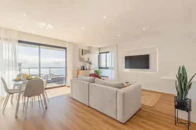 a living room with a couch and a table at Garajau Sea Side by Atlantic Holiday in Caniço
