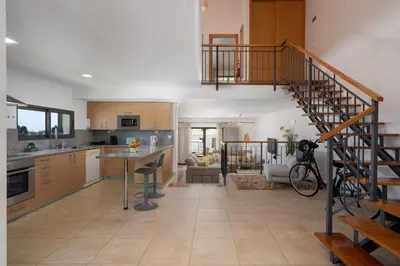 a kitchen and living room with a spiral staircase at MarAnteMar by An Island Apart in Porto Santo