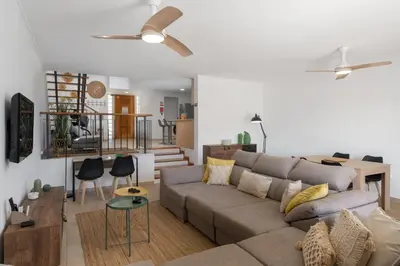 a living room with a couch and a table at MarAnteMar by An Island Apart in Porto Santo