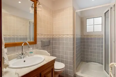 a bathroom with a sink and a toilet and a mirror at Casa da Avo in Faial