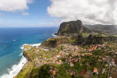 an aerial view of a village on a mountain next to the ocean at Casa da Avo in Faial