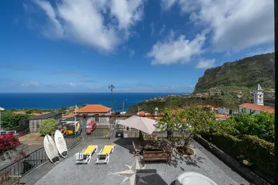 a view of a patio with surfboards and chairs at Casa da Avo in Faial