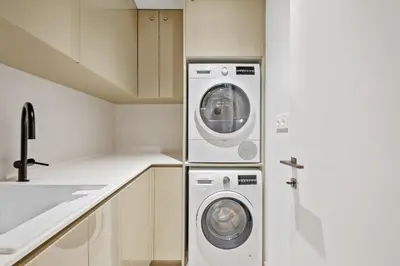 a kitchen with a washing machine and a washer and dryer at Infinity Pool and Open Views at Savoy Insular in Funchal