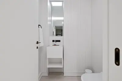 a white bathroom with a sink and a mirror at Infinity Pool and Open Views at Savoy Insular in Funchal