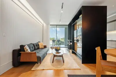 a living room with a couch and a table at Infinity Pool and Open Views at Savoy Insular in Funchal