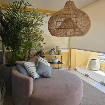 a living room with a couch and some plants at Casa Azul in Luz