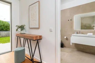 a bathroom with a table next to a sink at Elysium São Vicente - Designer Villa with Ocean View, Heated Pool, Jacuzzi & Sauna in São Vicente