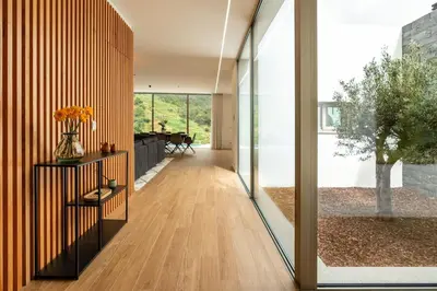 a hallway of a house with sliding glass doors at Elysium São Vicente - Designer Villa with Ocean View, Heated Pool, Jacuzzi & Sauna in São Vicente