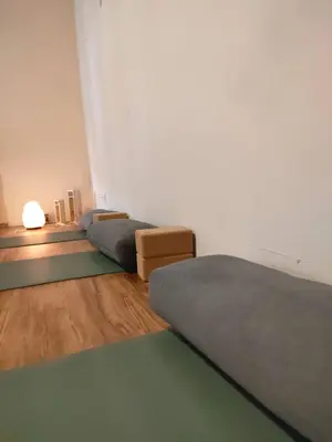 a room with three beds and a table with a lamp at Casa Fidal in Bordeira