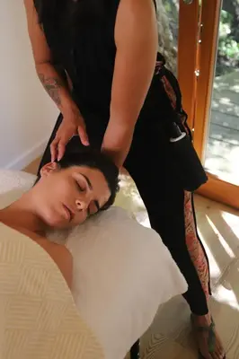 a woman laying on a bed with a person on her back at Casa Fidal in Bordeira