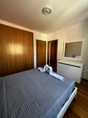 a bedroom with a large bed with a blue blanket at Island Heart- Family Retreat- Free parking garage in Ribeira Brava