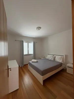 a white bedroom with a bed and a window at Island Heart- Family Retreat- Free parking garage in Ribeira Brava
