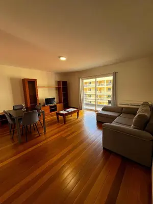 a living room with a couch and a table at Island Heart- Family Retreat- Free parking garage in Ribeira Brava