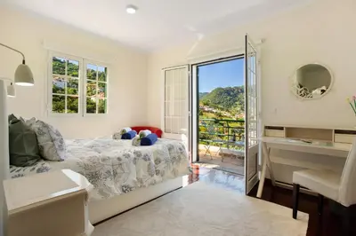 a bedroom with a bed and a window with a view at Traveller's House in Machico