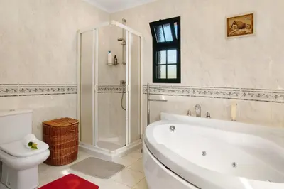 a white bathroom with a tub and a toilet at Traveller's House in Machico