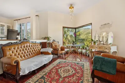 a living room with a couch and chairs and a table at Traveller's House in Machico