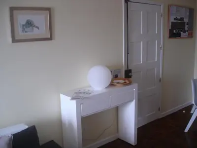 a white table in a room with a door at Shearwaternest Apartment AL in Funchal