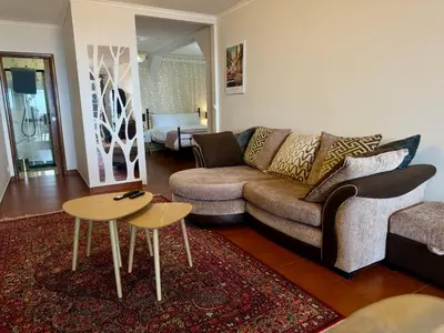 a living room with a couch and a table at Airport Oasis in Santa Cruz
