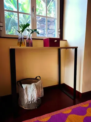 a desk with a window and a chair under it at Cascata da Giesta House in Câmara de Lobos