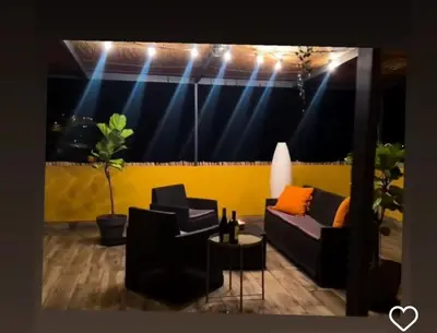 a room with two couches and a stage with lights at Cascata da Giesta House in Câmara de Lobos