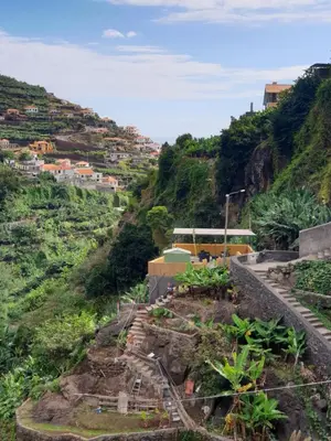 a view of a hill with a bus on it at Cascata da Giesta House in Câmara de Lobos