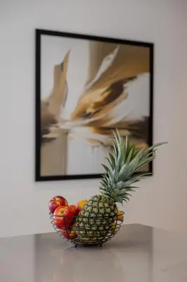 a bowl of fruit on a table with a pineapple at A&M House III in Arco da Calheta