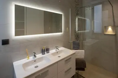 a white bathroom with a sink and a mirror at A&M House III in Arco da Calheta