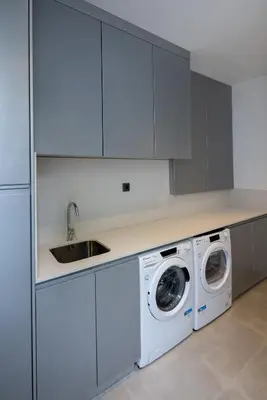 a white kitchen with a sink and washing machines at A&M House III in Arco da Calheta