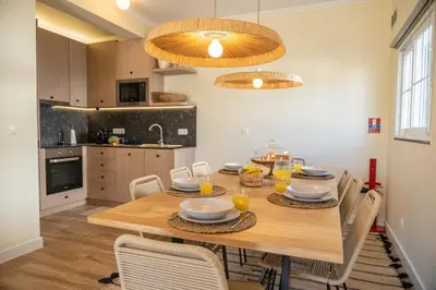 a dining room with a wooden table and chairs at Beach Retreat - By Wehost in Porto Santo