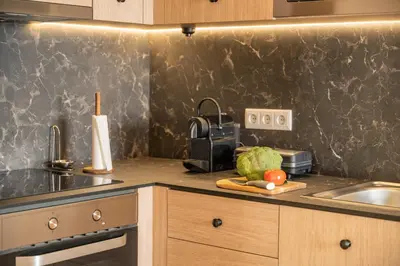 a kitchen counter with a sink and a cutting board with vegetables at Beach Retreat - By Wehost in Porto Santo