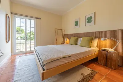 a bedroom with a large bed and a window at Beach Retreat - By Wehost in Porto Santo
