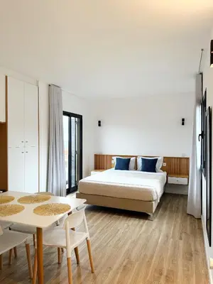 a bedroom with a bed and a table at S A L - Village Flats in Caniçal