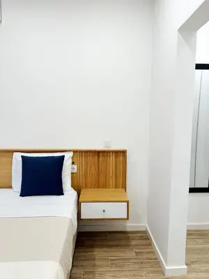 a bedroom with a bed with a blue pillow at S A L - Village Flats in Caniçal