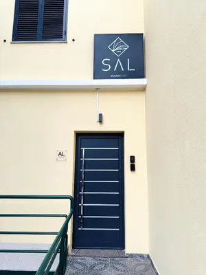 a blue door on the side of a building at S A L - Village Flats in Caniçal