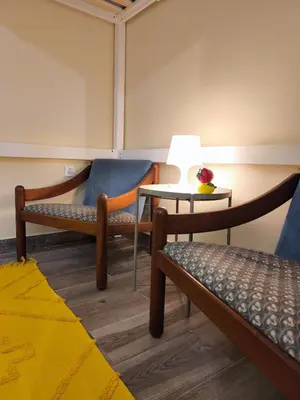 a room with two chairs and a table with a lamp at Studio Cascata da Giesta in Câmara de Lobos