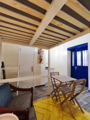 a living room with a table and chairs at Studio Cascata da Giesta in Câmara de Lobos